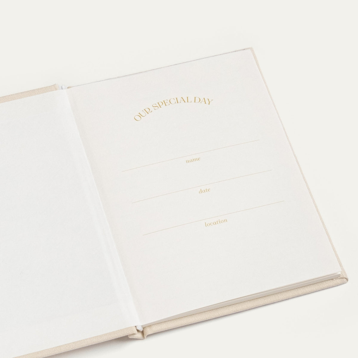 Inside cover of the ivory vow book with OUR SPECIAL DAY in gold foil and lines for date, name and location